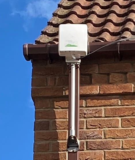 4G/5G antenna fixed high on the outside wall of a house